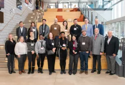 Emerging Leaders in the Americas Program delegates and UPEI representatives on the academic staircase in the UPEI Faculty of Sustainable Design Engineering building.