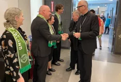 photo of man shaking hand with another man in receiving line