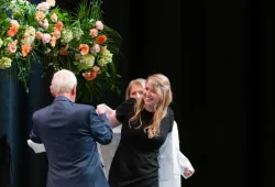 Student receives their white coat at graduation