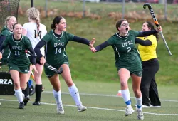 UPEI Field Hockey Panthers Jenaya Ross (#11) and Kali Smith (#14) help Kayla Batchilder (#2) celebrate her game-winning goal against Dalhousie University which secured a U SPORTS bronze medal for the team on home turf.