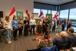 photo of a group of students holding pieces of ribbon