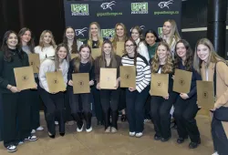 Members of the UPEI Women’s Hockey team gather for a photo after they receive their U SPORTS Academic All-Canadian certificates.