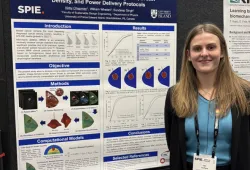 Abby Chapman stands next to the research poster she presented at the 2026 Society of Photo-Optical Instrumentation Engineers (SPIE) Medical Imaging Conference, held in Vancouver, BC, from February 14-19, 2026. 