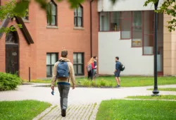 Student walking in the quad in spring