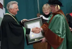 Major-General (Retired) Matthew Macdonald (right) received his honorary degree in 2014 from then Chancellor Dr. Don McDougall. 