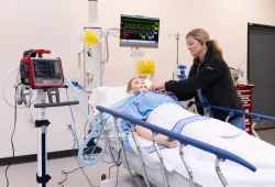 Jaclyn Sanderson, Simulation Program Assistant Manager, performs a simulation on a manikin in the Clinical Learning and Simulation Centre