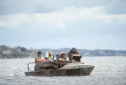 four shellfish harvesters on an oyster boat