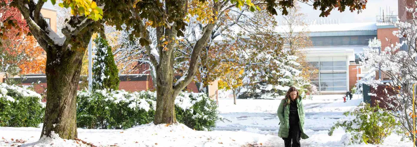 a student walking on campus in the winter