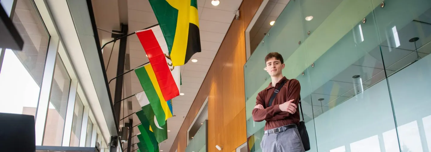 a student in Schurman Market Street with flags above