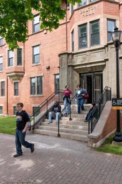 five students in fall outside UPEI's Dalton Hall