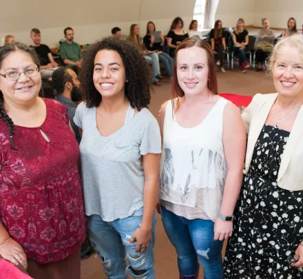 four people leading a group lecture
