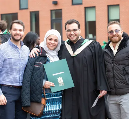 family and friends congratulate a UPEI graduate