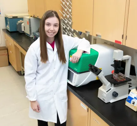 female researcher and microscope