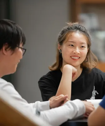 students speaking in the Library