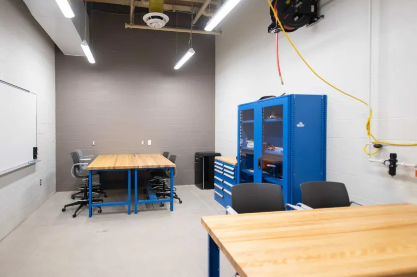 student workstations and blue desks in a shop area in the Faculty of Sustainable Design Engineering building