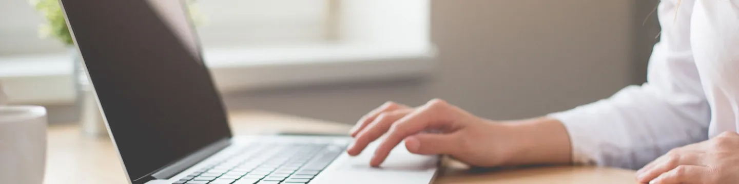 Person's hand using a laptop