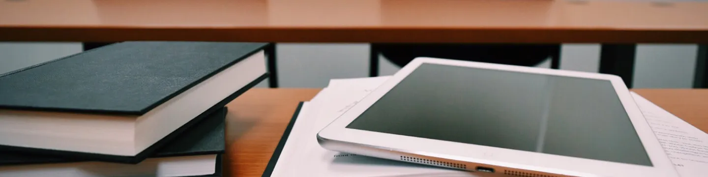 Books and a tablet on a table