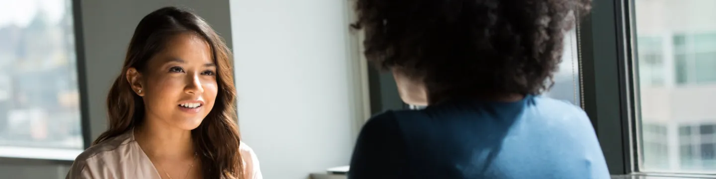 two people talking at a white table