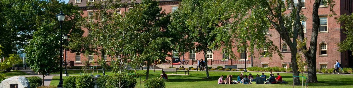 a group sitting outside UPEI main building 