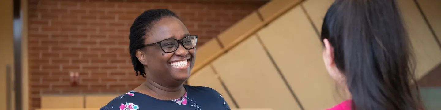 nursing graduate Henrietta talking with another student 