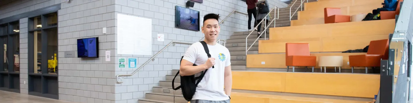 UPEI engineering student Yvan in the Faculty of Sustainable Design Engineering building lobby