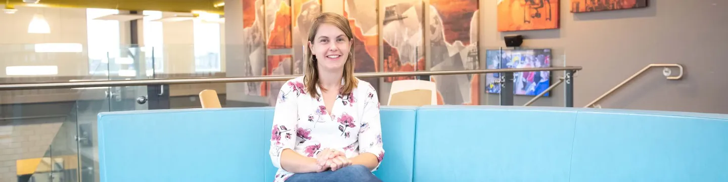 a professor sitting on a modern couch 