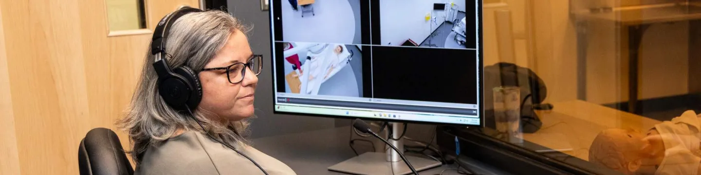 UPEI simulation coordinator Kerie Murphy using a computer