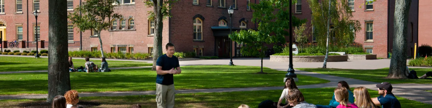 students listening to an outdoor lecture in the quad