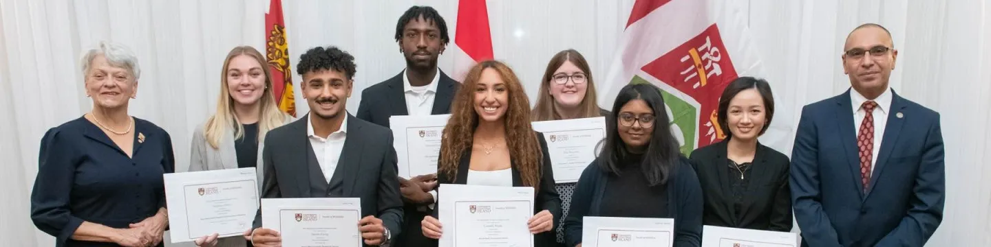 students holding awards