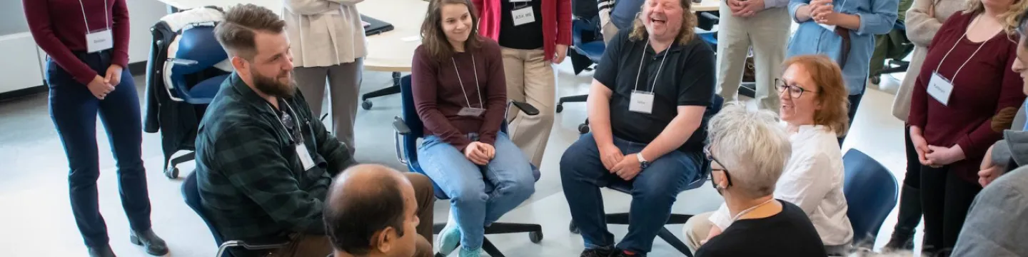 a group of UPEI instructors laughing during a workshop