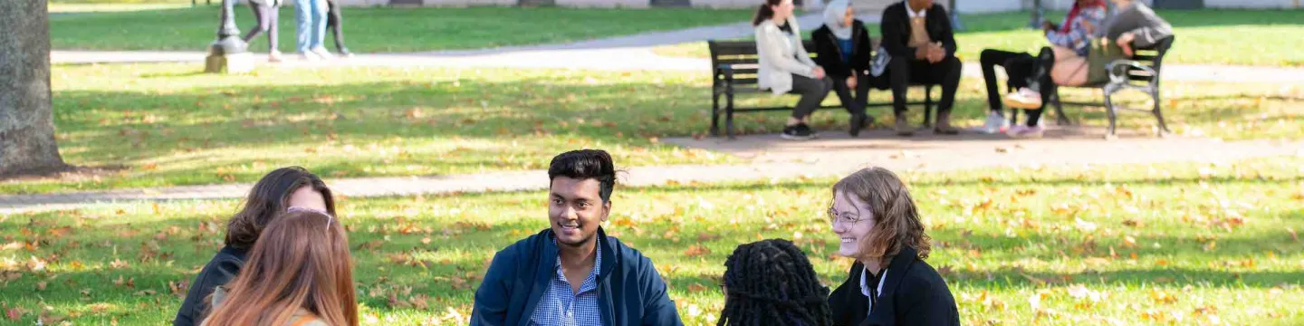 a group of 5 students sitting in the UPEI quad 