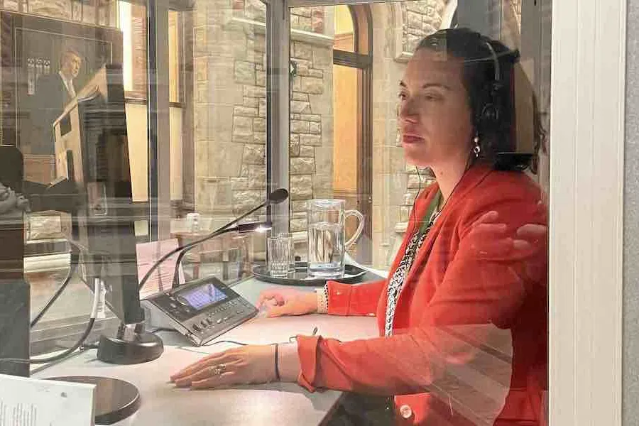 Deidre Kelly wearing headphones, working at Parliament Hill