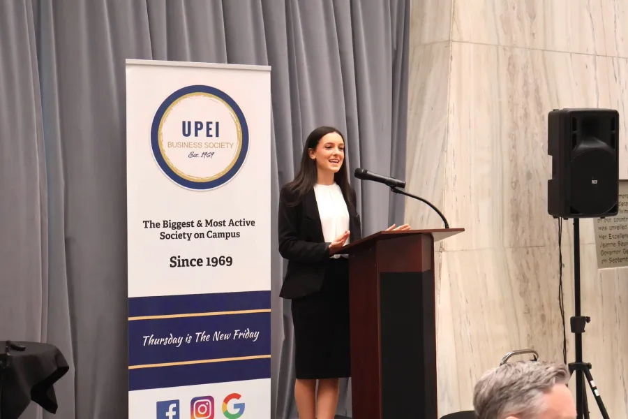 Charlize Sahely speaking at a podium