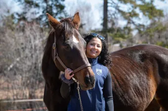 UPEI veterinary medicine student Anam in an outdoor paddock