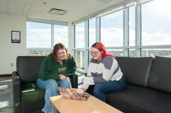 two UPEI students in the Performing Arts Centre and Residence lounge