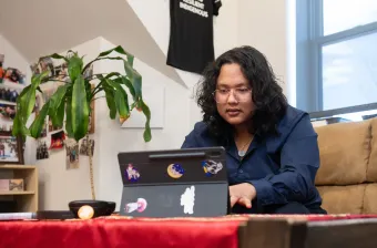 a UPEI student working on a laptop computer