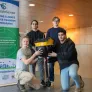 four students standing with a data buoy they created 