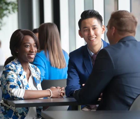 Students sit at a table talking