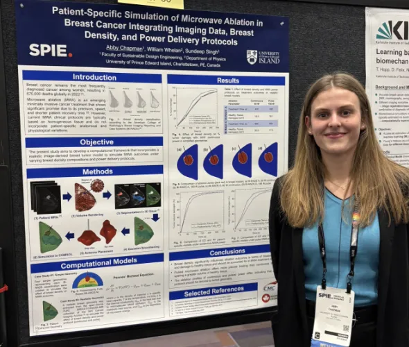 Abby Chapman stands next to the research poster she presented at the 2026 Society of Photo-Optical Instrumentation Engineers (SPIE) Medical Imaging Conference, held in Vancouver, BC, from February 14-19, 2026. 