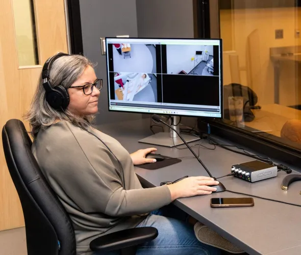 UPEI simulation coordinator Kerie Murphy using a computer