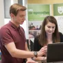 A student staff member helps a student in the career studio